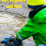 Red Wigglers and Kids child playing in a mud puddle.