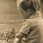 Red Wigglers and Kids small girl holding a cat on her lap.