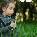 Vermicomposting For Kids girl blowing on a dandelion.