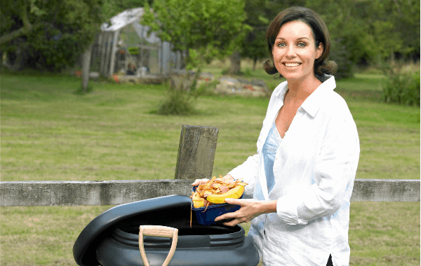 Vermicompost Project lady with a worm bin feeding organic waste