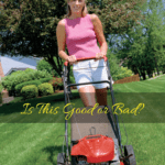 Woman mowing the grass with a push mower.