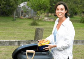 Vermicompost Project lady with a worm bin feeding organic waste